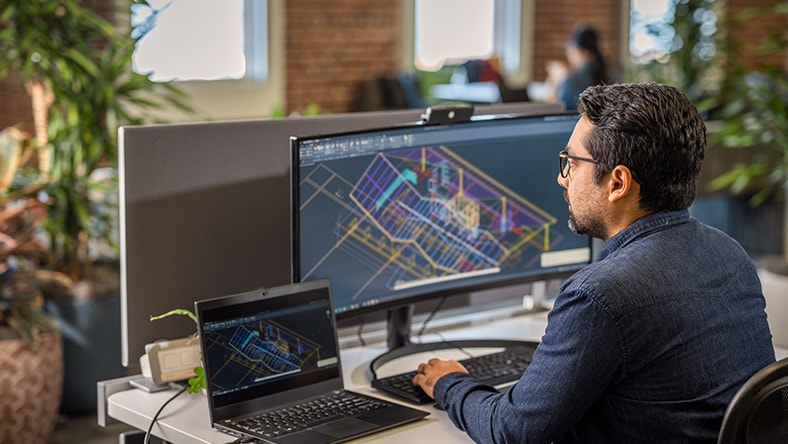 Man using AutoCAD in an office environment.