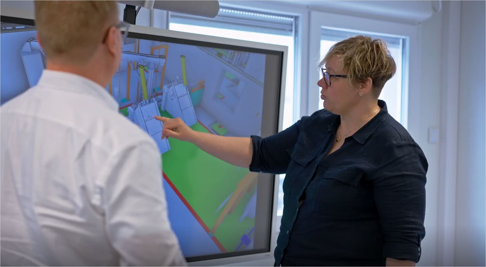 Individual pointing to a computer screen 