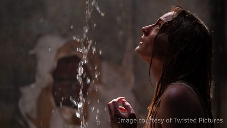 A scared woman from a film by Twisted Pictures.