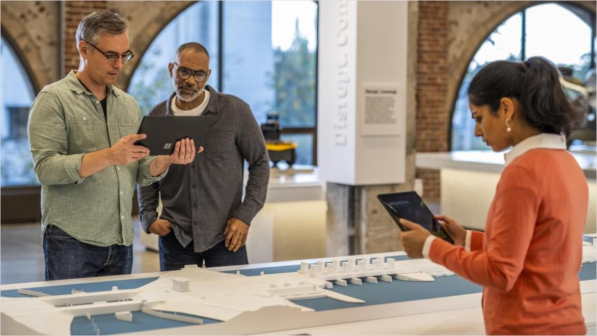 Educators reviewing a building model and digital design using Autodesk tools in a collaborative workspace
