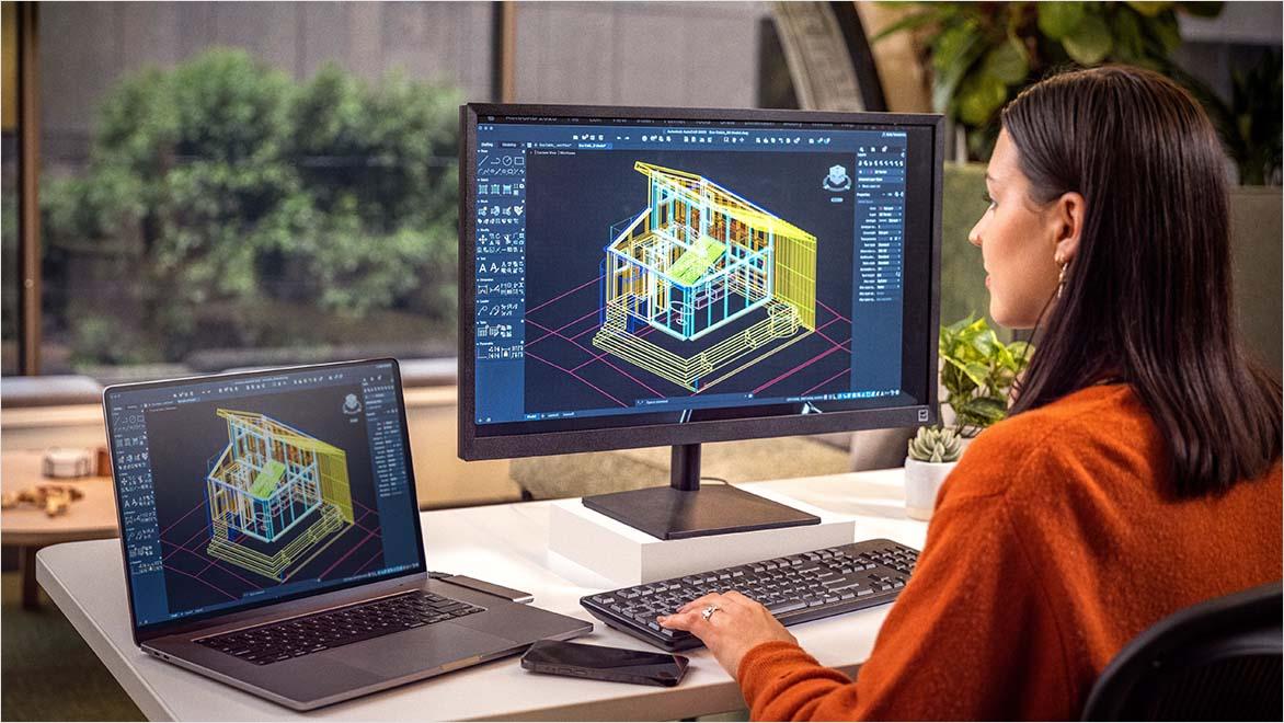 Woman using AutoCAD in an office environment.