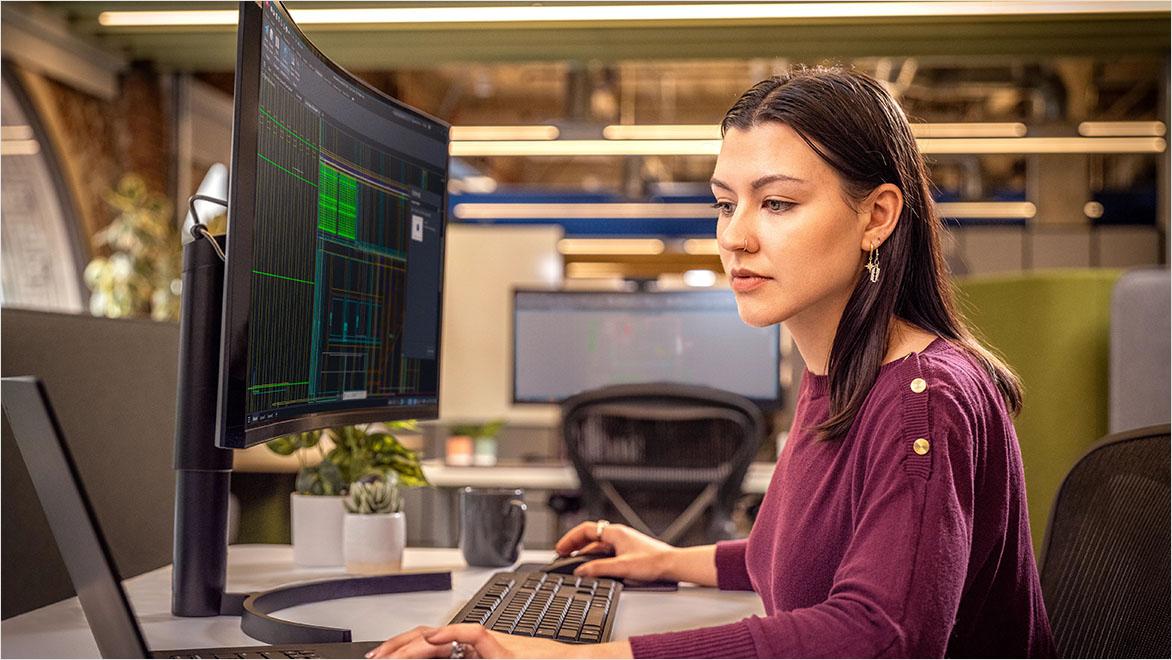 Woman using AutoCAD in an office environment.