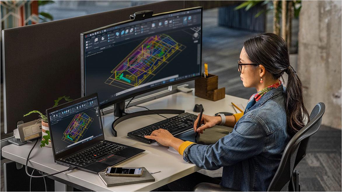 Designer working on AutoCAD building model.