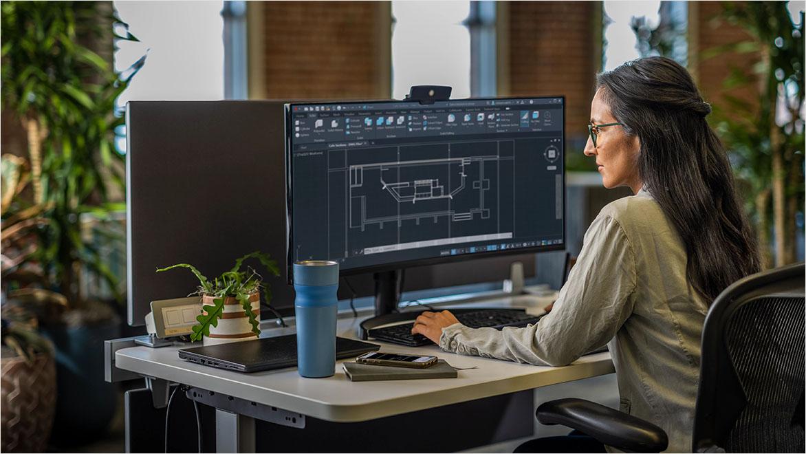 Designer working on AutoCAD floor plan.