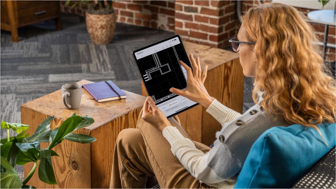 People using AutoCAD in a home office environment.