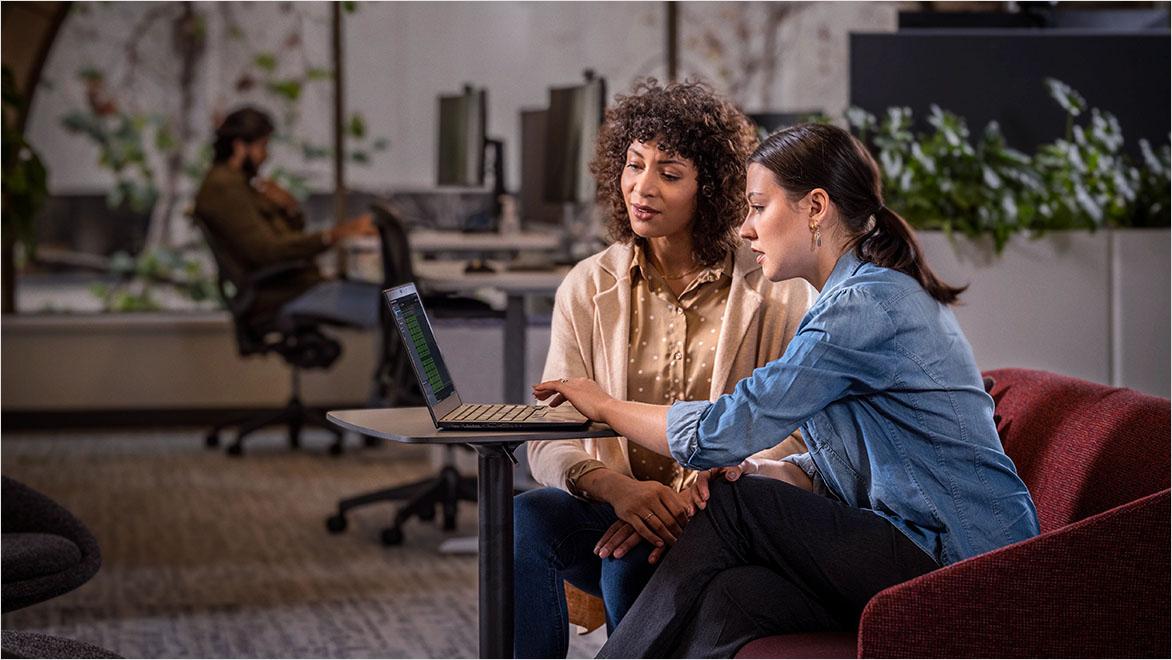 Women collaborating and viewing a tablet.