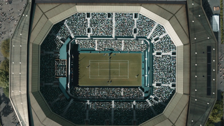 Animated character addressing a large audience in a cinematic 3D scene.