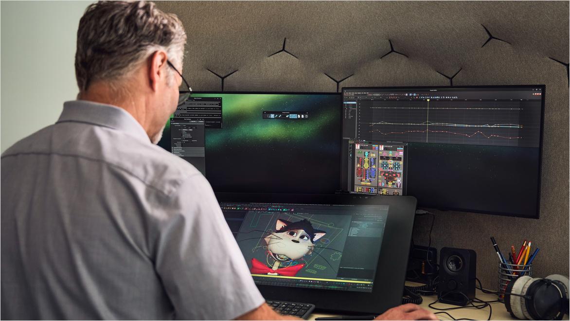 Marek Kochout, The Cat in the Hat animator, works on a digital character model using a pen display and multiple monitors. 
