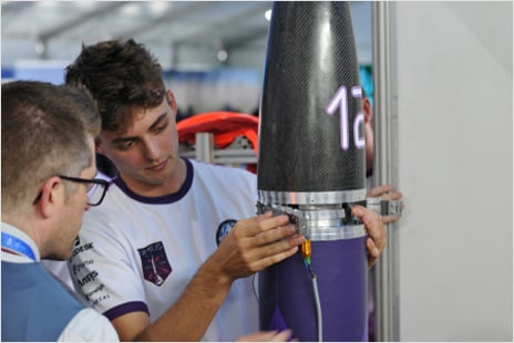 A student works on his team's rocket design
