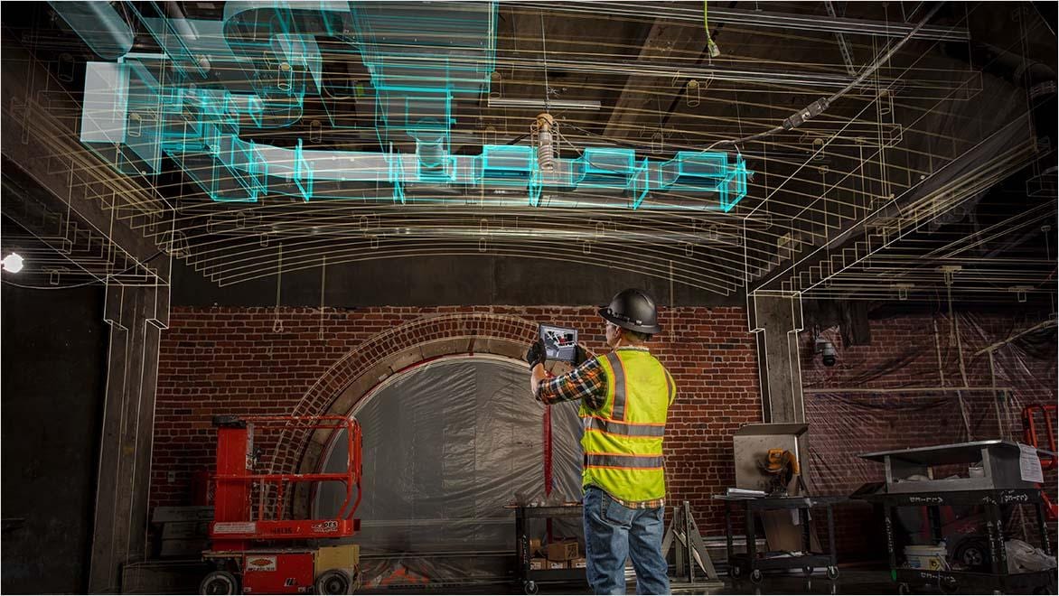 Construction worker using AI-powered AR technology on a building site.