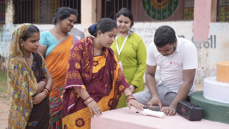 People using a non-invasive hemoglobin testing device.