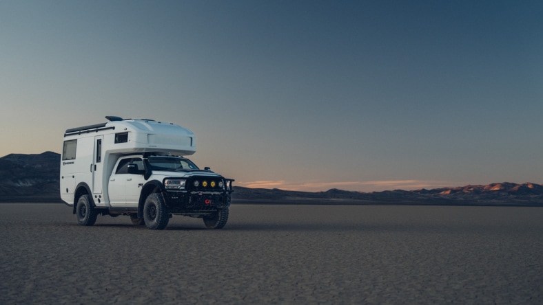 TruckHouse expedition vehicle in an outdoor landscape.