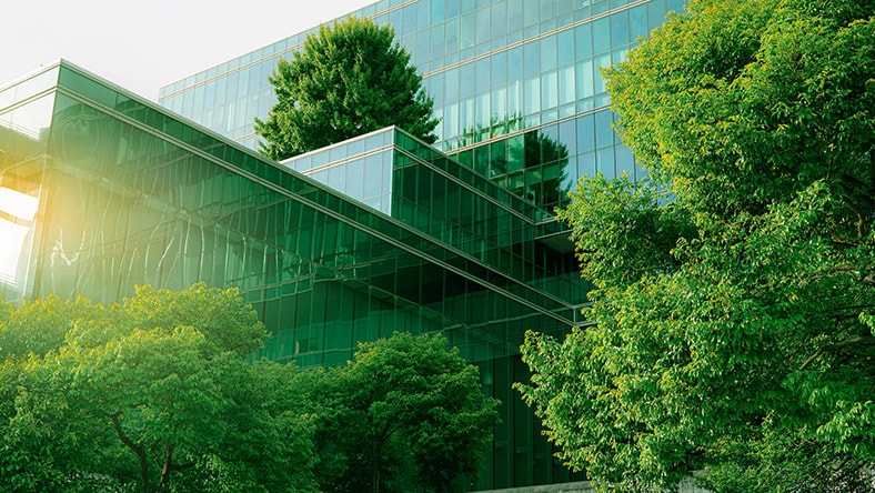 A sustainable office complex is surrounded by greenery.