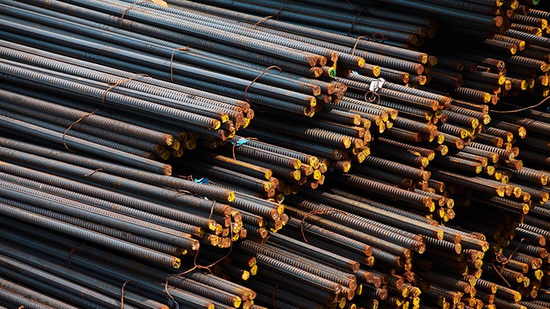 A pile of rebar sits in a warehouse.