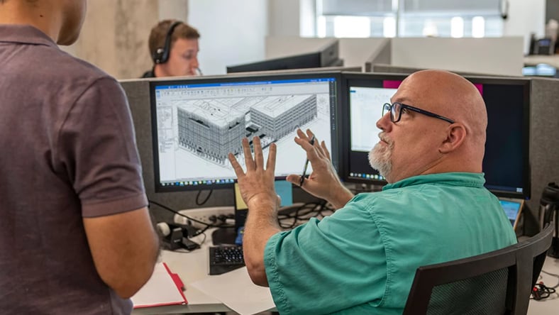 Man in front of computer with 3d modeling