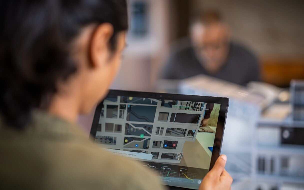 Employee looking at a 3D building model on a tablet