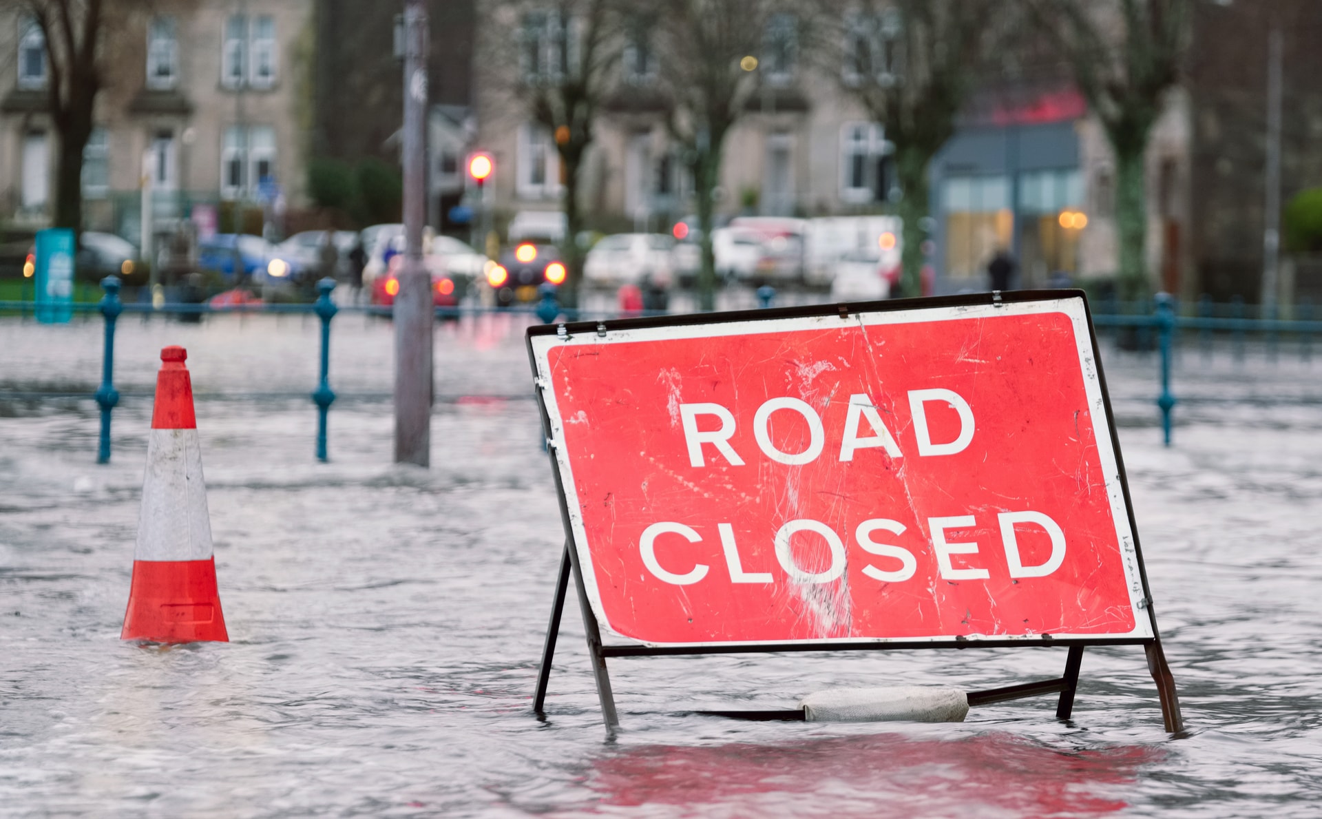 flooded street with road closure sign