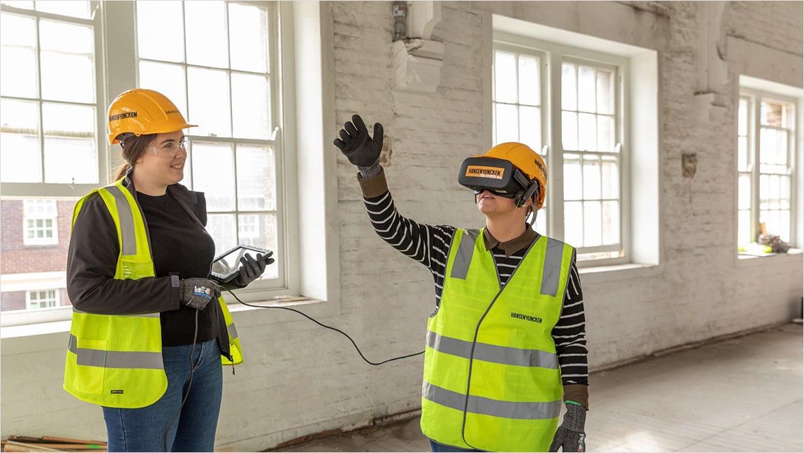 Woman showcasing building design in VR