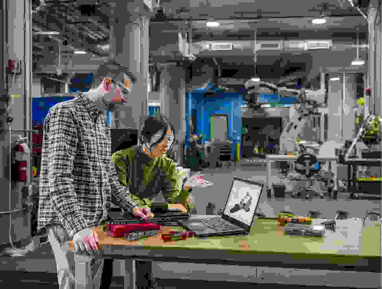 Man and women using Autodesk Fusion CAM software.