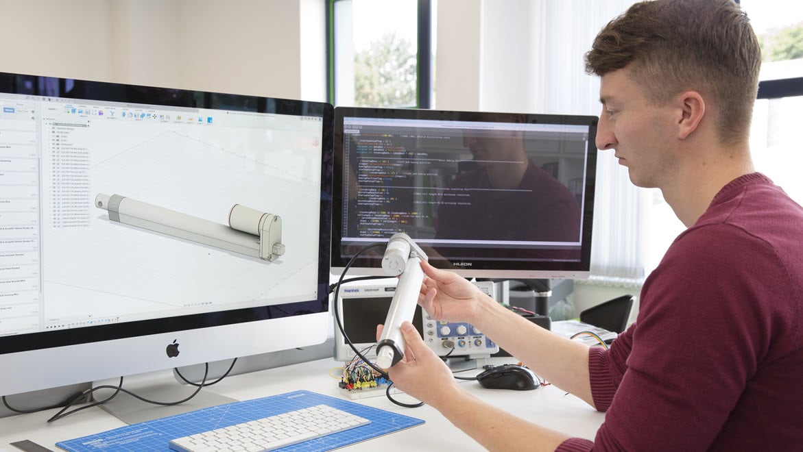 Image from customer, Iterate UK, showing a consumer product design team at work in their studio. Includes electronics, 3D printing, sketching, and simulation.