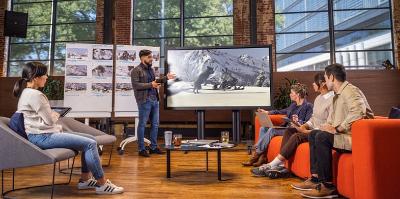 Team discussing a film edit and review in a media and entertainment studio.