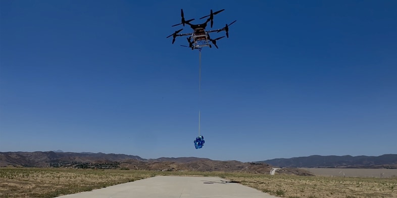 An unmanned aerial vehicle flies above ground during a research test.