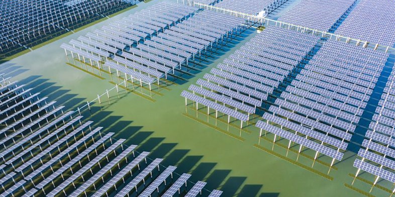 Aerial view of solar panels in water.