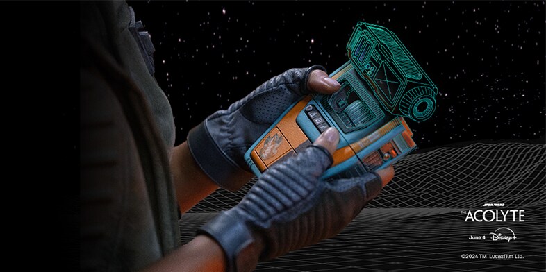 A person holding a Pip droid from the Star Wars universe.
