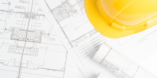 blueprints with a yellow hardhat