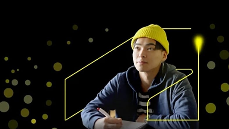 Man wearing winter hat in an abstract background with the Autodesk logo around him