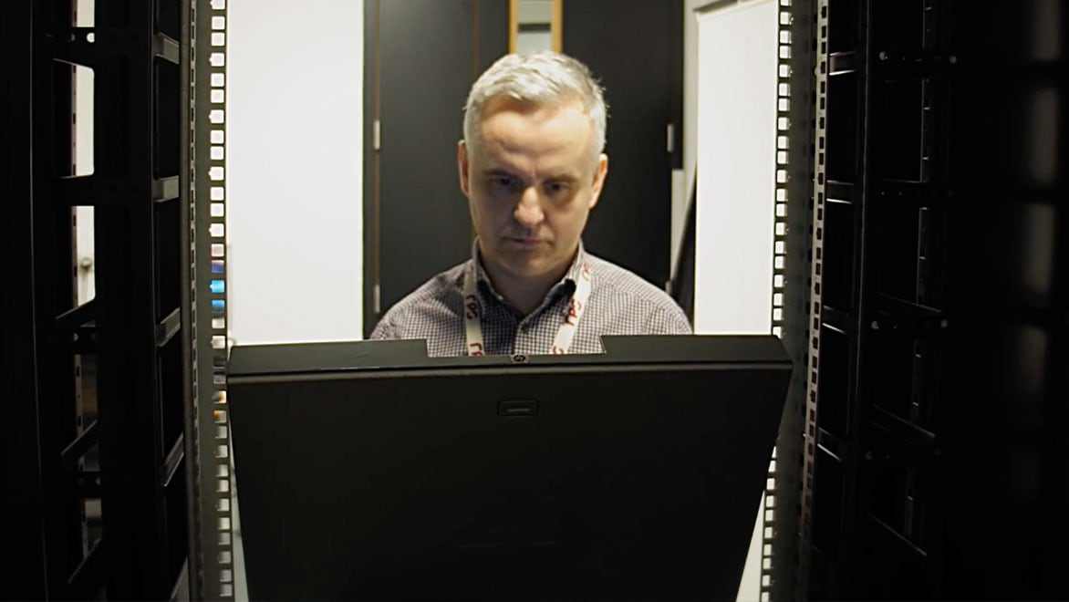 Man staring down at computer system