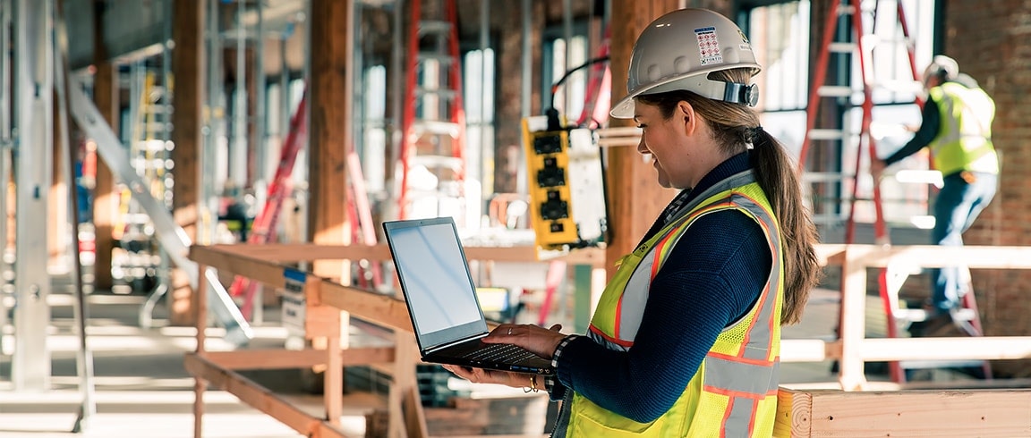 Construction worker using laptop on construction site