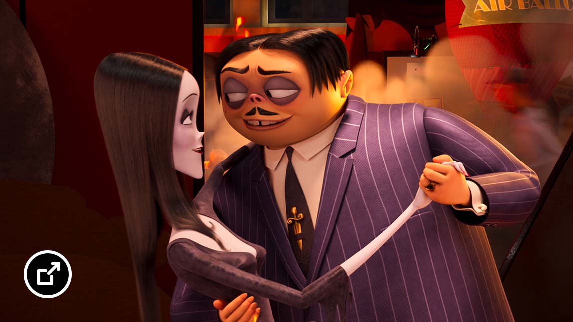Morticia and Gomez Addams dancing together  