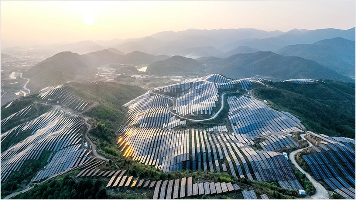Rolling green hills with solar panels layered on top 