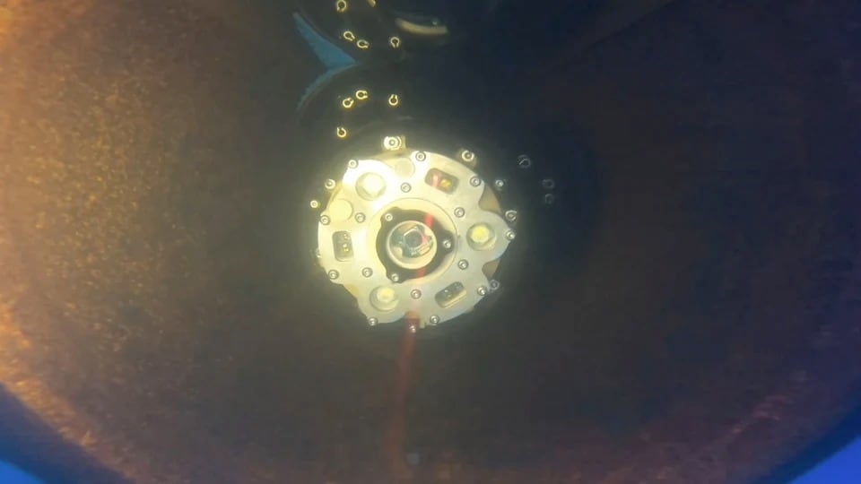 An underwater image shows an autonomous robot navigating a water pipe collecting data.