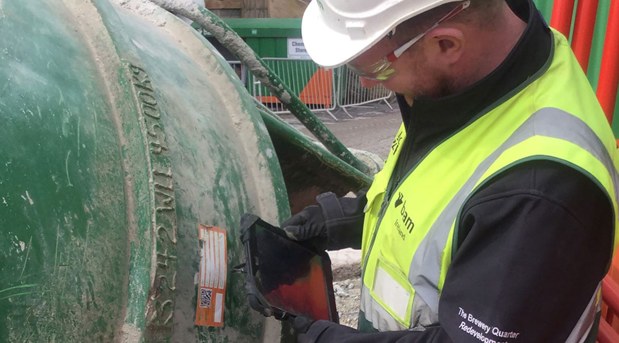  Construction worker scans a tag on a cement mixer