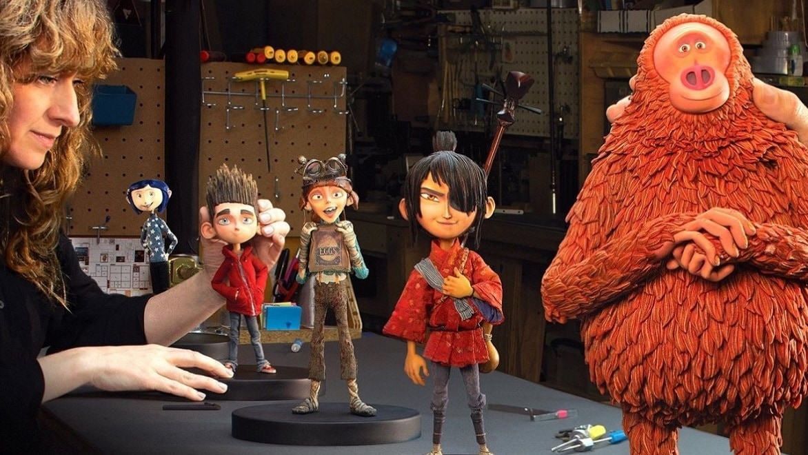 Five detailed puppets representing the main characters of LAIKA movies positioned on a table