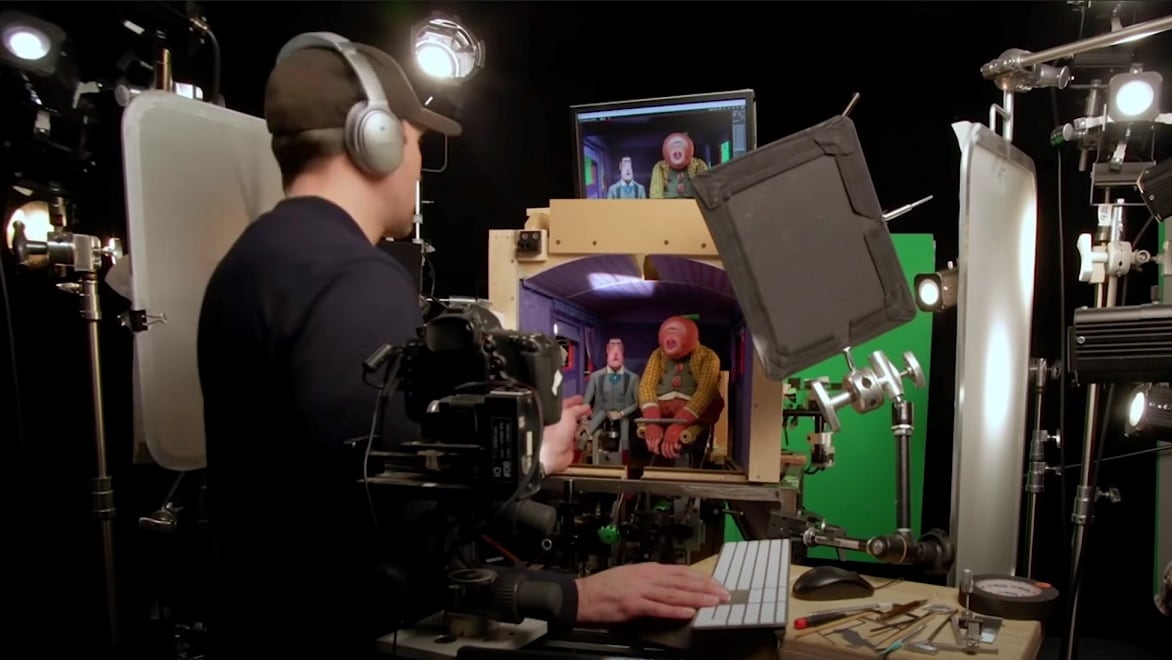 A stop-motion animator manipulates the puppets to shoot a scene for the film Missing Link