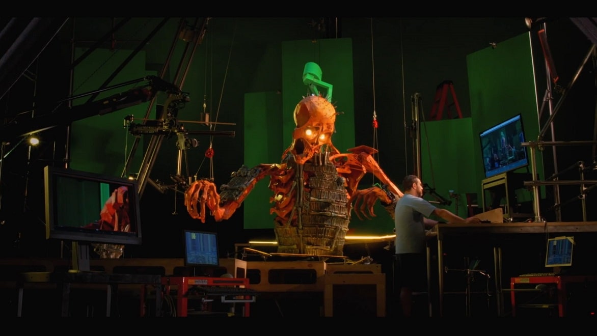 A puppeteer manipulates a giant skeleton puppet