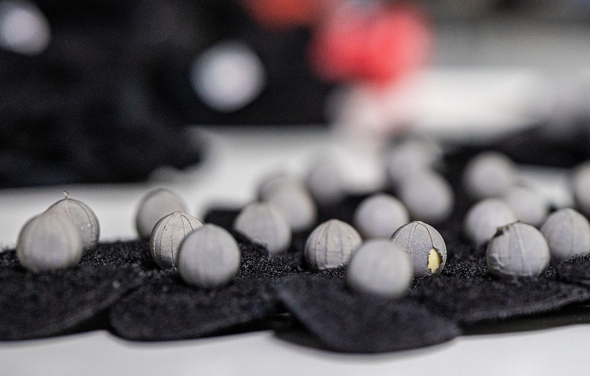 Felt pads with multiple grey felt balls attached to them.