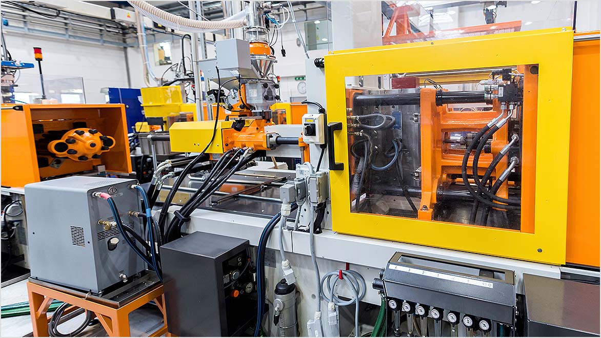 Factory floor showing injection molding equipment 