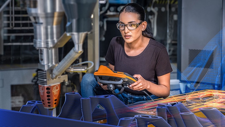 A woman in a technology center creating something with additive manufacturing