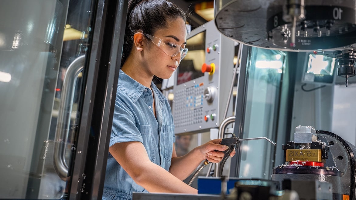 Young woman working in a CNC lab