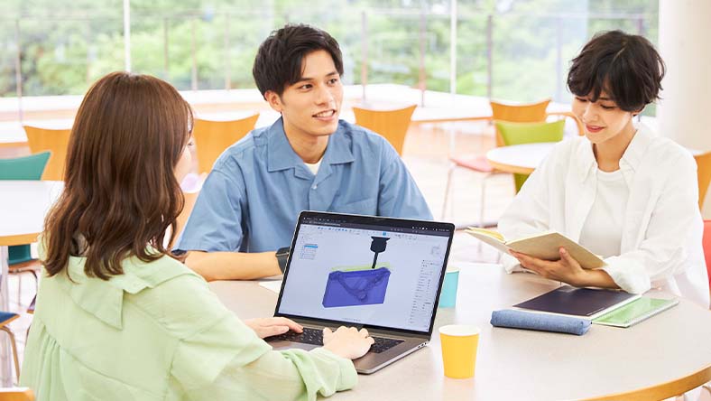Teacher helping student in a computer lab