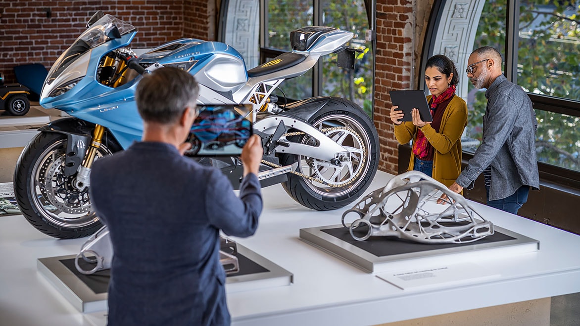 People taking a photo of a motorcycle in the Autodesk Gallery 