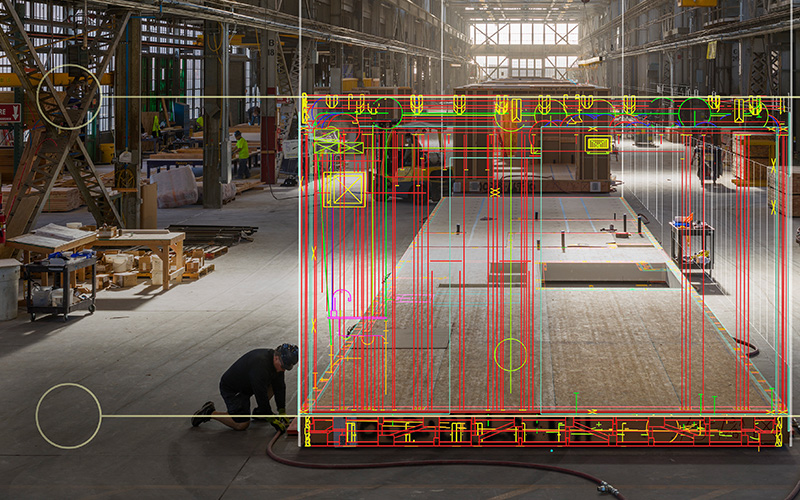A digital design overlaid on a building under construction in the Factory_OS construction facility