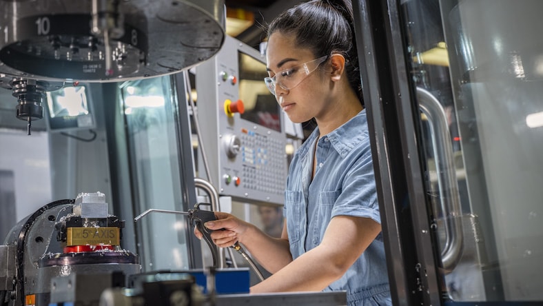 A woman works in the CNC lab at Diablo Valley College in Pleasant Hill, California.  