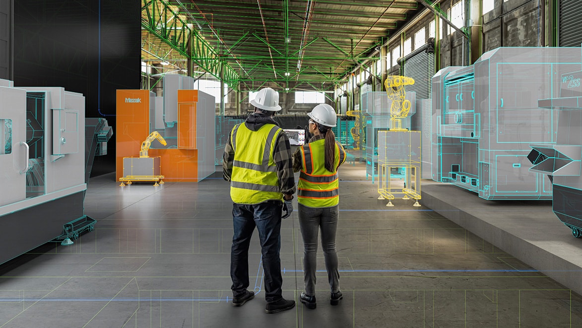 Two construction workers in safety gear reviewing a digital twin of a pre-fab factory floor, with AI-generated machine models and robotic equipment overlaid on the real environment.