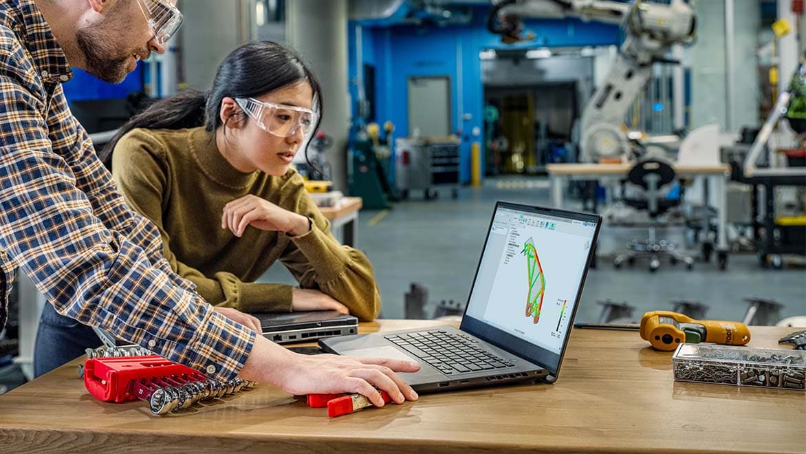 Autodesk employees collaborating at the Autodesk Boston Technology Center in Boston, MA. Fusion 360 is on the laptop screen.
