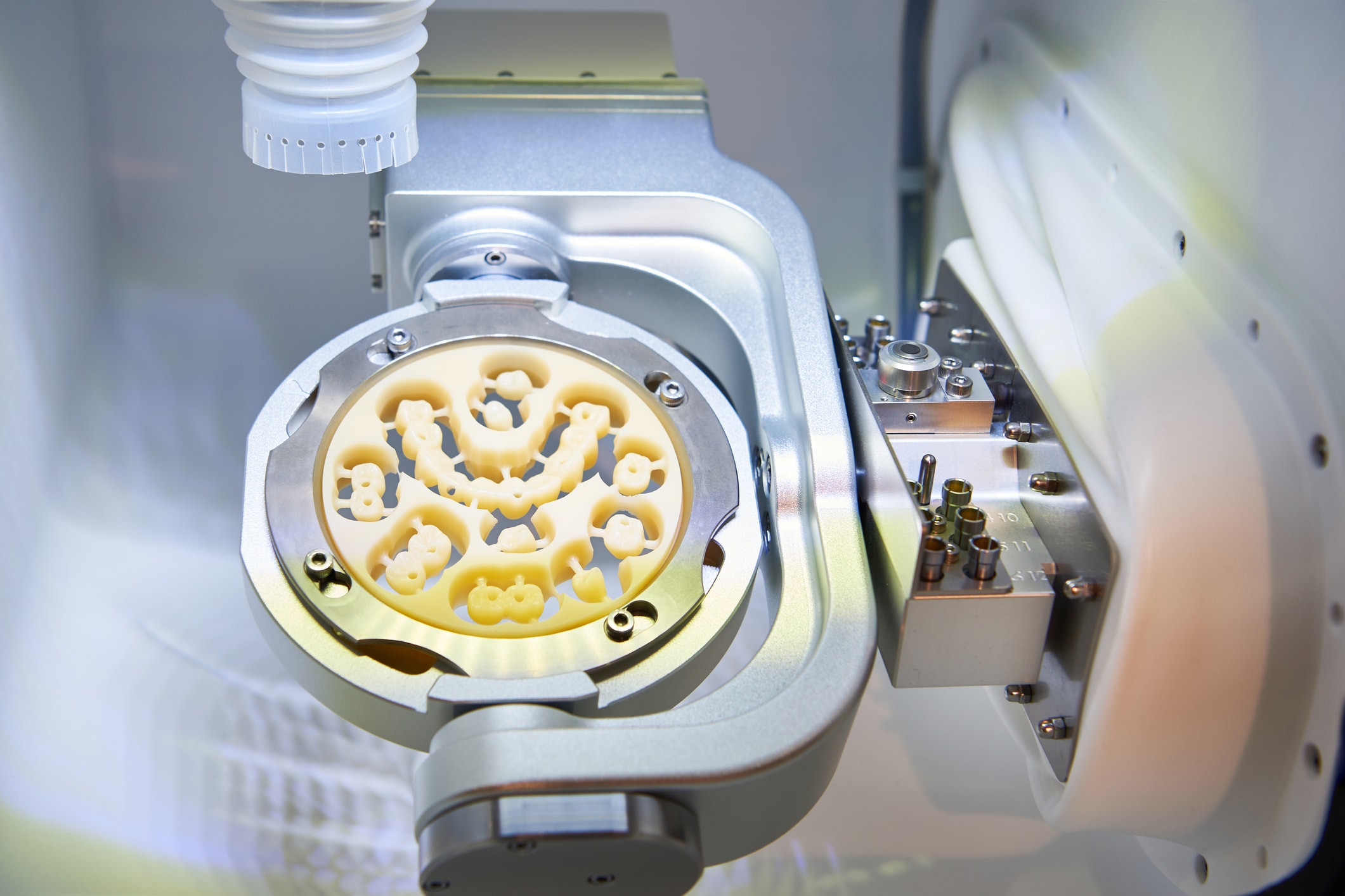 1282629611 A dental prosthesis milling machine carves out dental crowns.